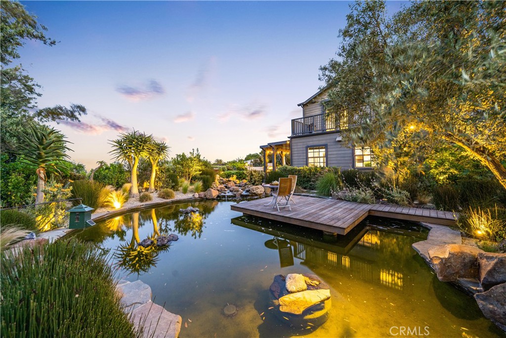 28850 Hampton Place Malibu, CA 90265 - Photo 45 of 53 a view of a swimming pool with tables and chairs under an umbrella