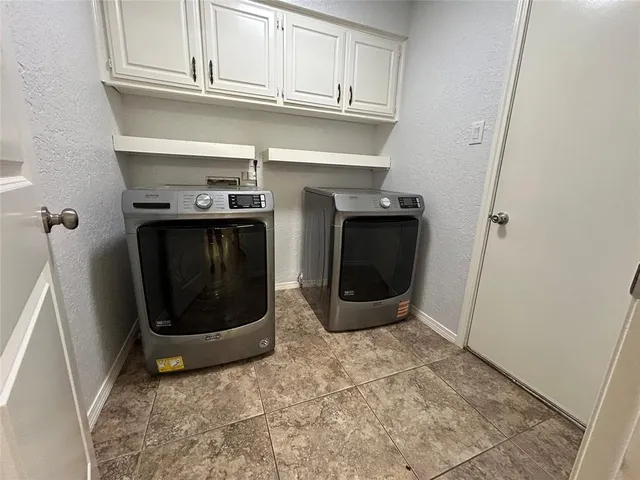 a utility room with washing machine
