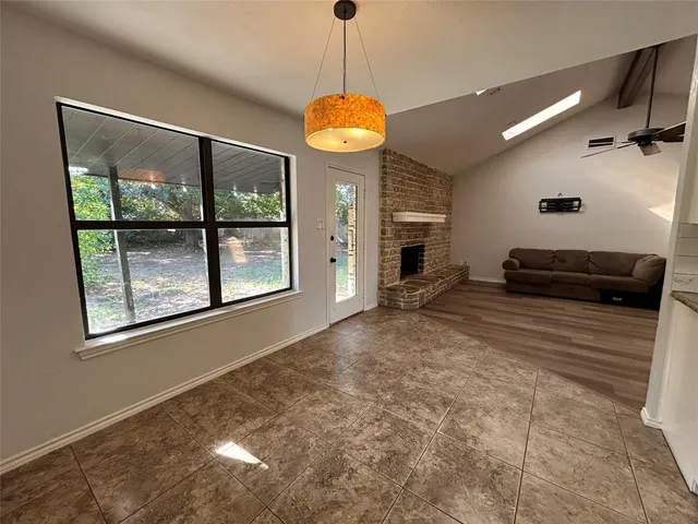 a view of a room with a large window and chandelier