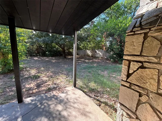 a view of a backyard with a tree