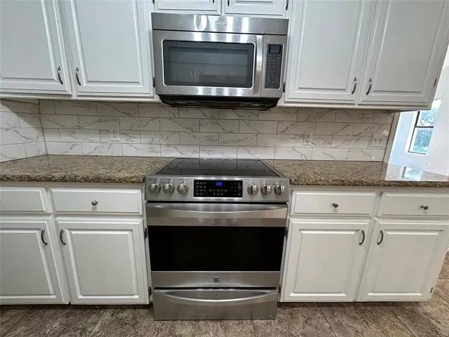 a stove top oven sitting inside of a kitchen