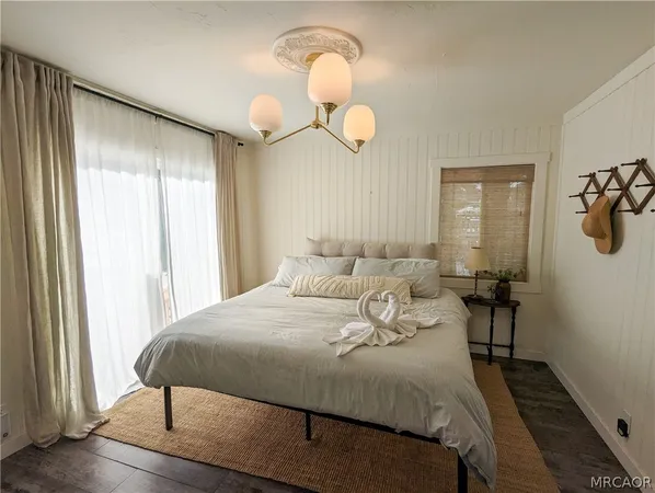 a bedroom with a bed and a chandelier