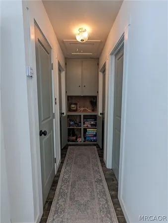 a view of hallway with wooden floor