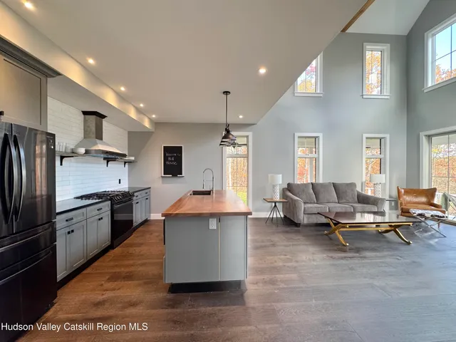 a kitchen with stainless steel appliances kitchen island granite countertop a refrigerator and a stove top oven