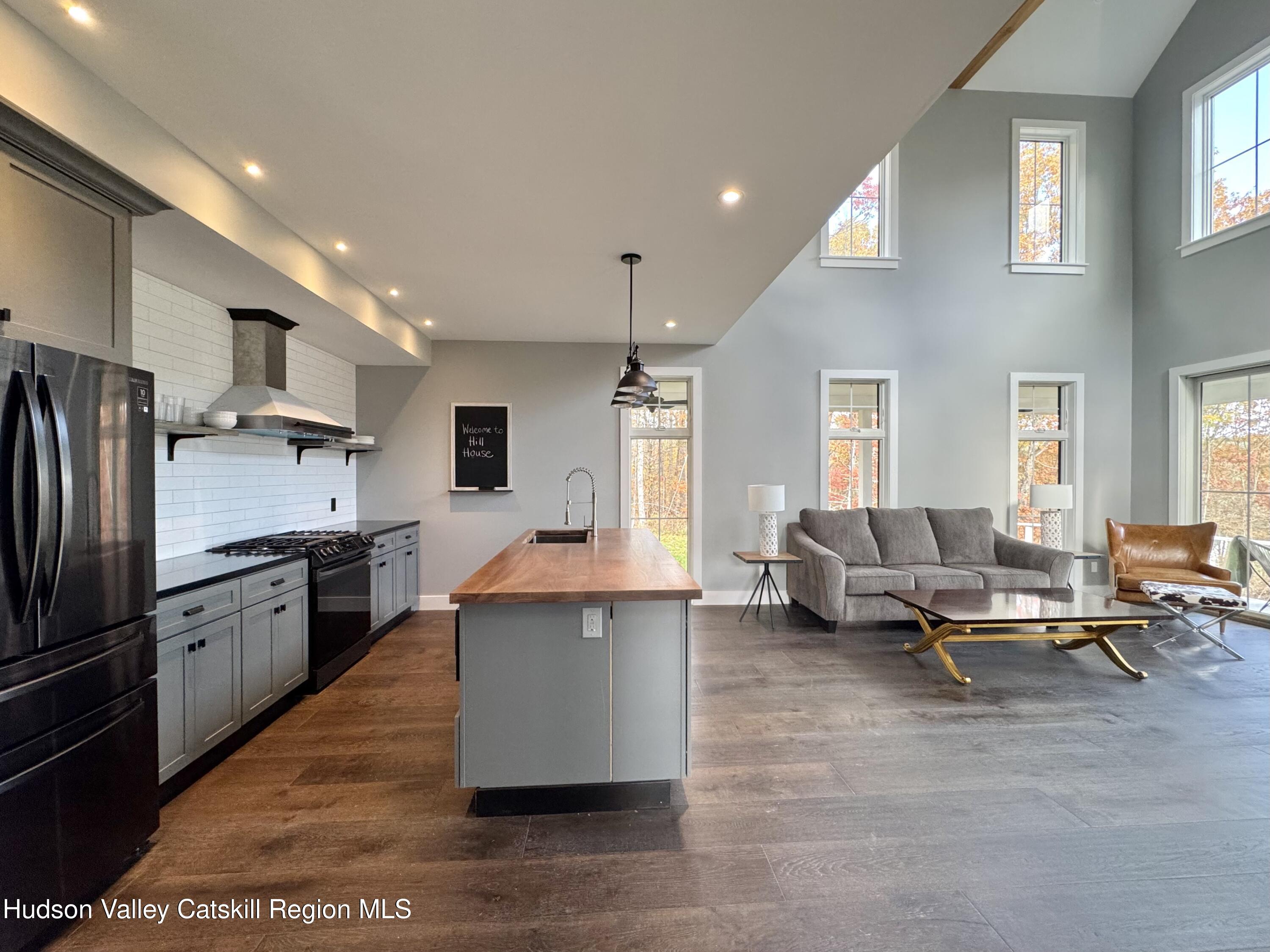 720 Sunny Hill Road Greenville, NY 12083 - Photo 12 of 42 a kitchen with stainless steel appliances kitchen island granite countertop a refrigerator and a stove top oven