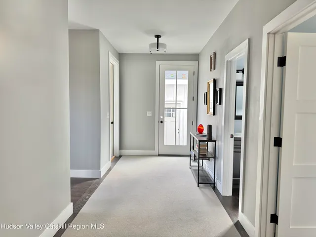 a view of a livingroom with wooden floor and a window