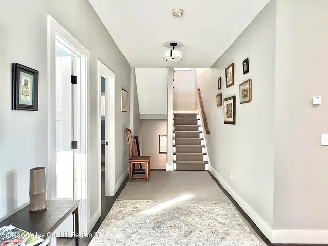 a view of entryway with furniture and wooden floor