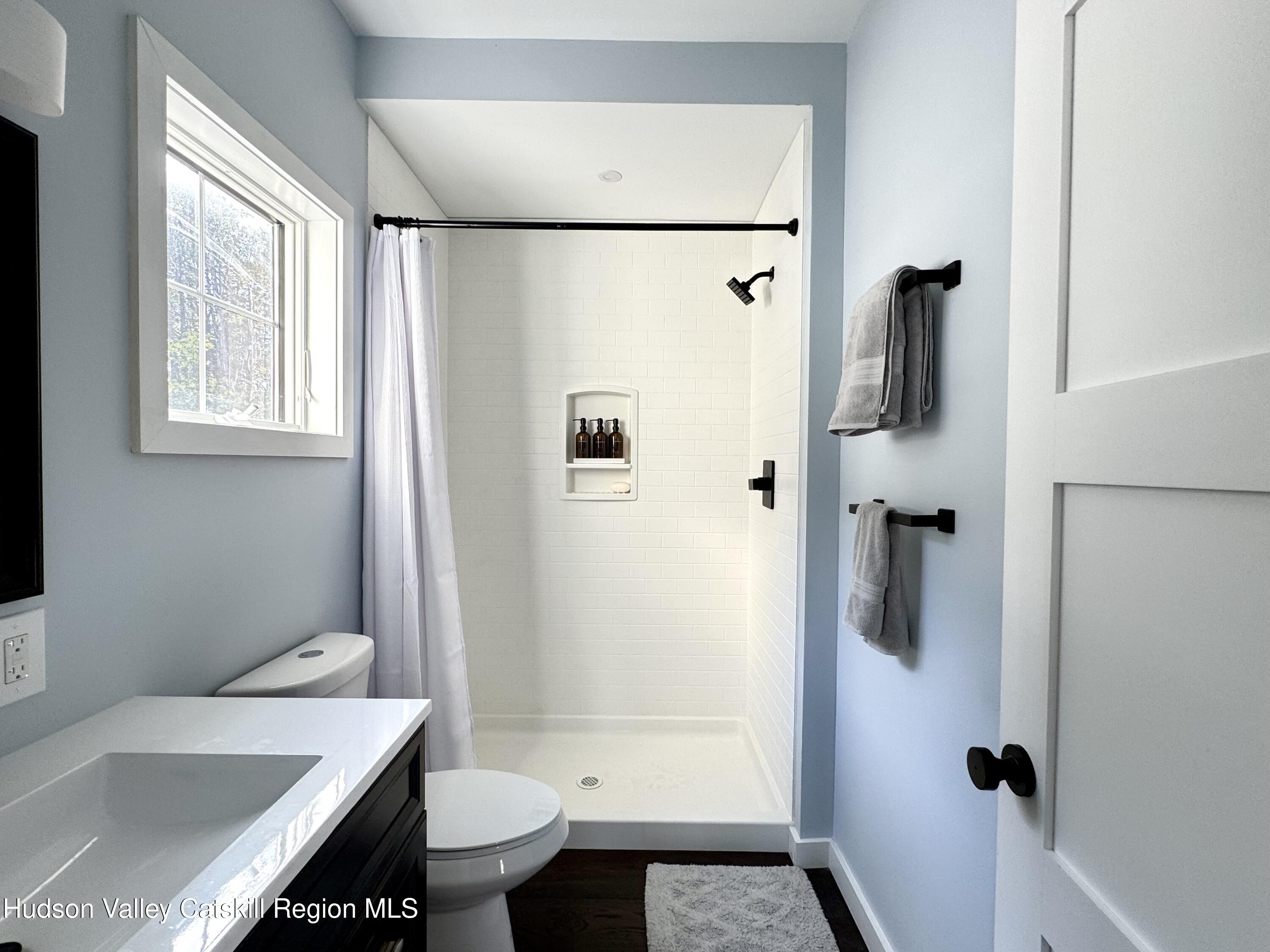 720 Sunny Hill Road Greenville, NY 12083 - Photo 20 of 44 a bathroom with a sink toilet and shower