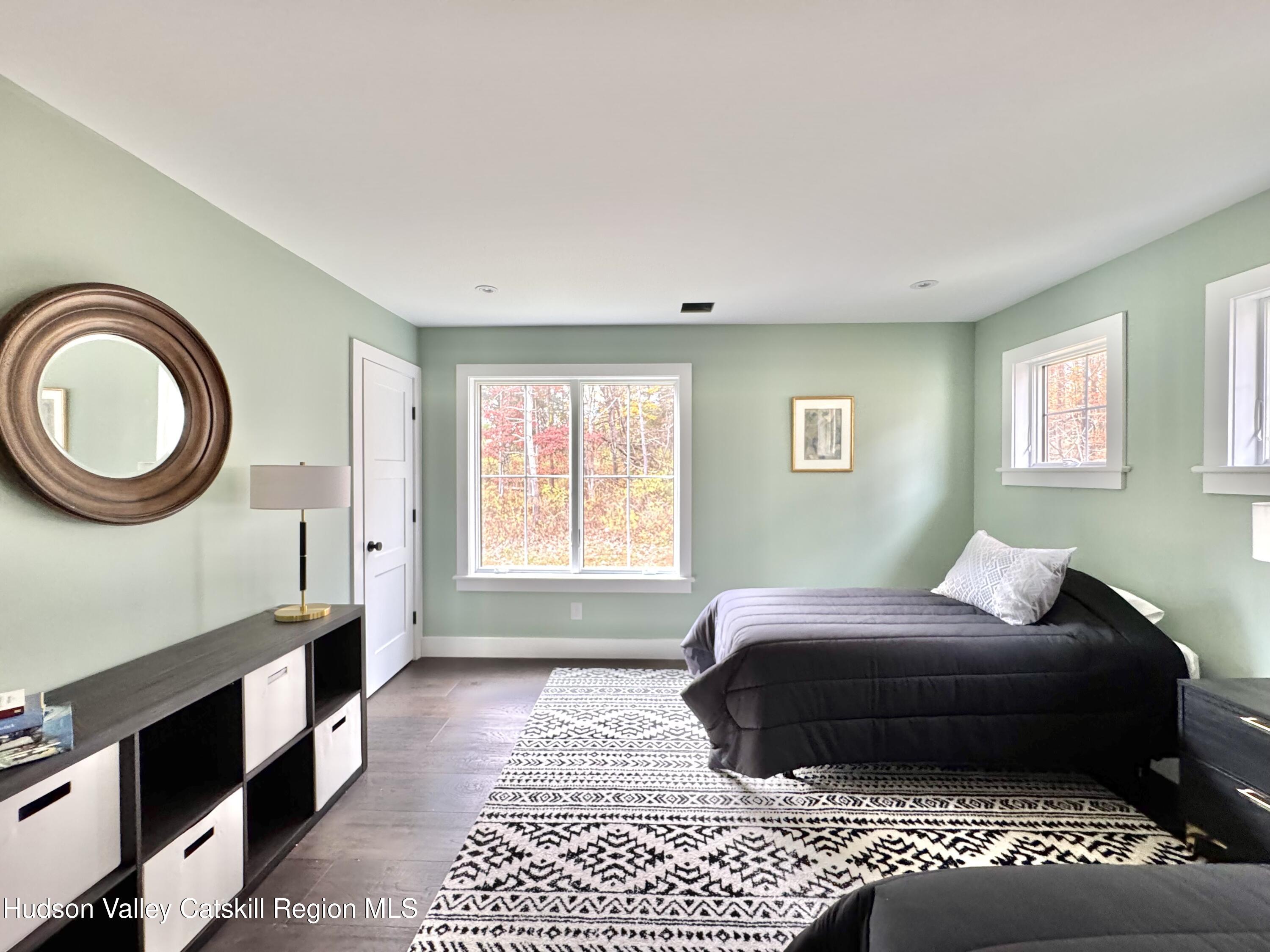 720 Sunny Hill Road Greenville, NY 12083 - Photo 24 of 42 a bedroom with a bed lamp and a window