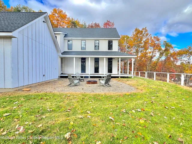 a view of a house with swimming pool porch and furniture
