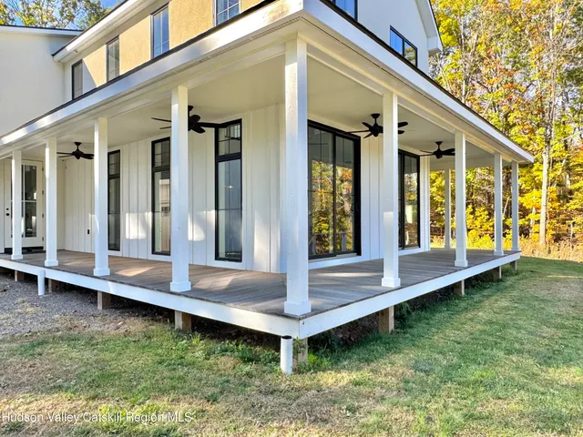 a view of a house with a yard and sitting area