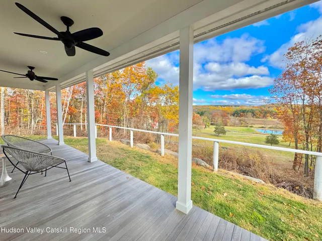 a view of a room with wooden floor and windows