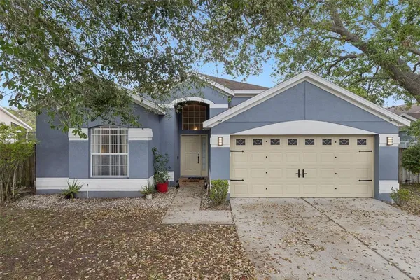a view of a house with a yard and garage