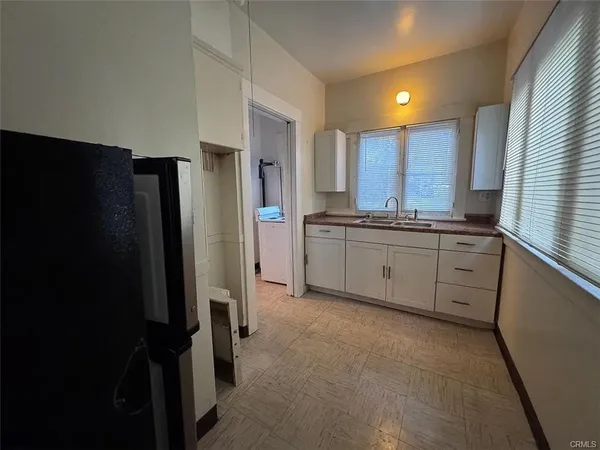 a kitchen with stainless steel appliances a refrigerator sink and cabinets