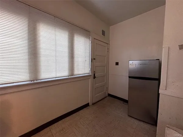 a kitchen with a refrigerator and a dishwasher