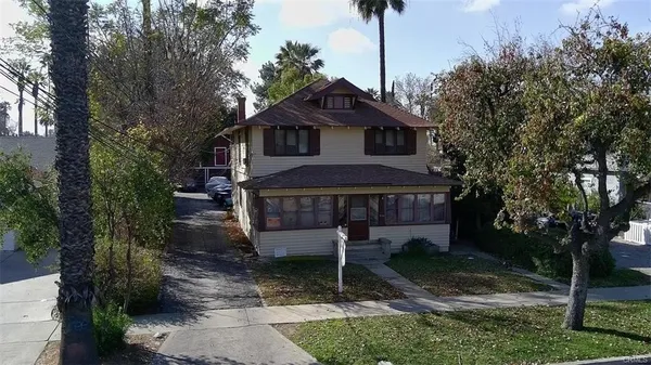 a front view of a house with a yard and mountain view