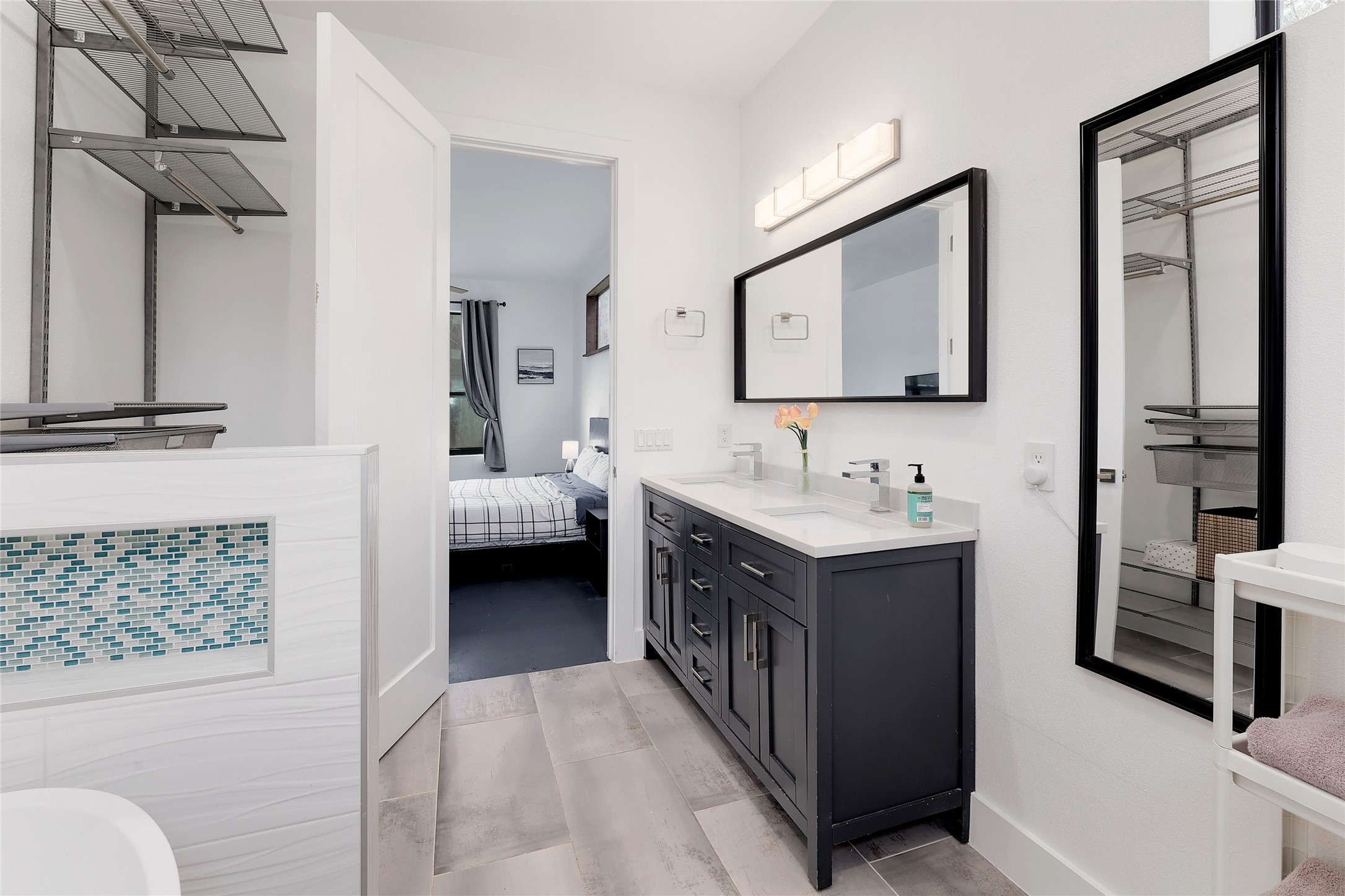 7001 Ranch Road 2222 Austin, TX 78730 - Photo 15 of 18 A well-appointed bathroom features a double vanity and sleek modern finishes, connected to a spacious closet.
