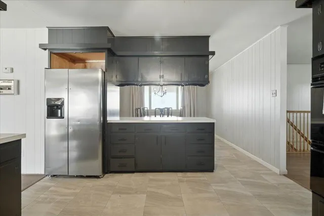 a bedroom with a bed couch and a large window