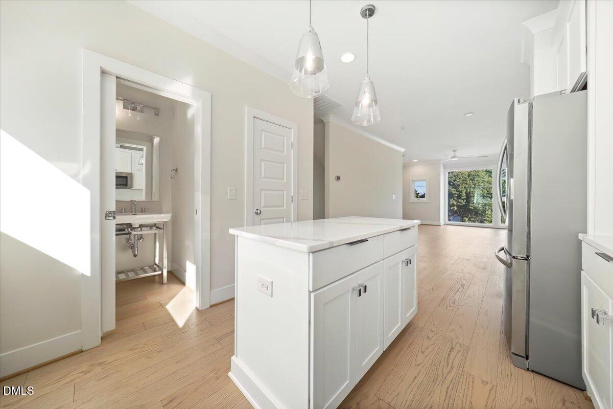 712 East Edenton Street, Unit 102 Raleigh, NC 27601 - Photo 5 of 17 a bathroom with a sink a mirror and a shower