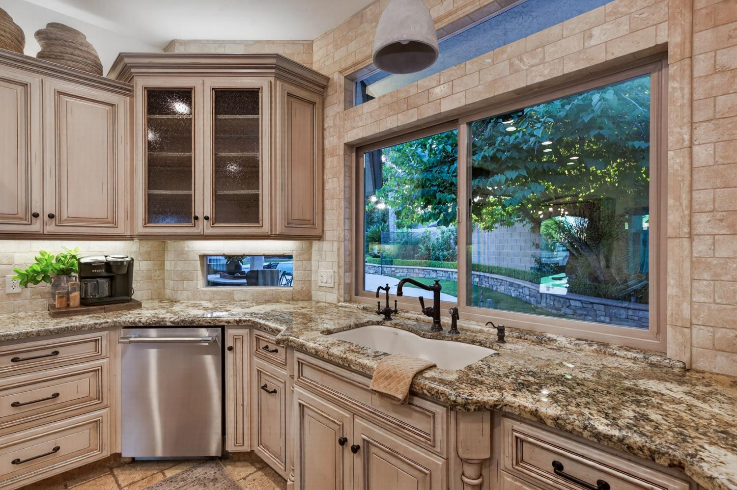 601 Decatur Avenue Clovis, CA 93611 - Photo 16 of 62 a kitchen with stainless steel appliances granite countertop a stove a sink and a counter space