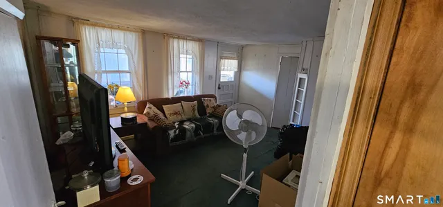 a view of a entryway with furniture and windows