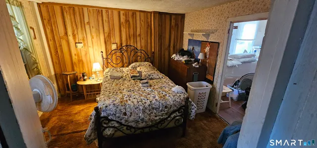 a bed sitting in a bedroom next to a window