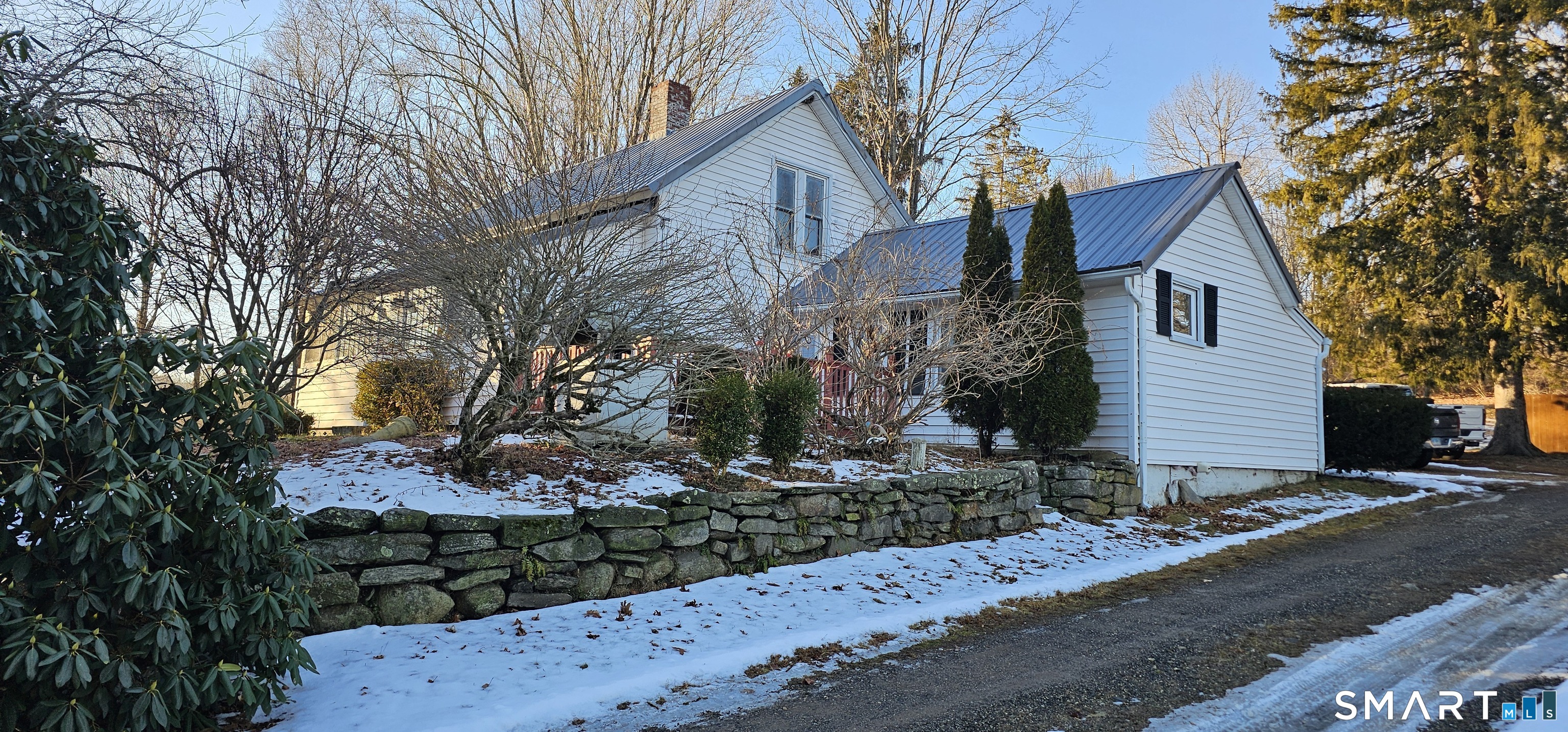 933 Hampton Road Pomfret, CT 06259 - Photo 4 of 16 a front view of a house with a yard and garage