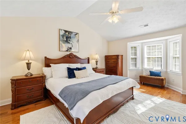 a bedroom with bed and wooden floor
