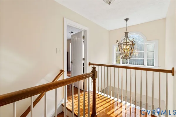 a view of hallway with wooden floor and stairs