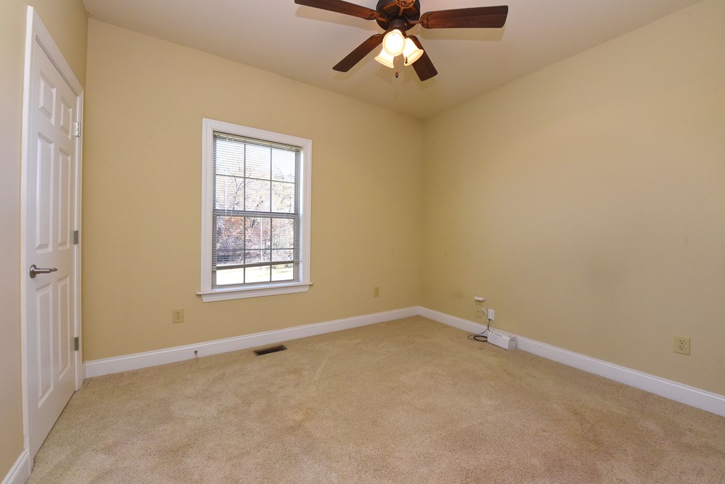 328 Asa Dorsey Road Cleveland, GA 30528 - Photo 18 of 35 an empty room with a window and a fan