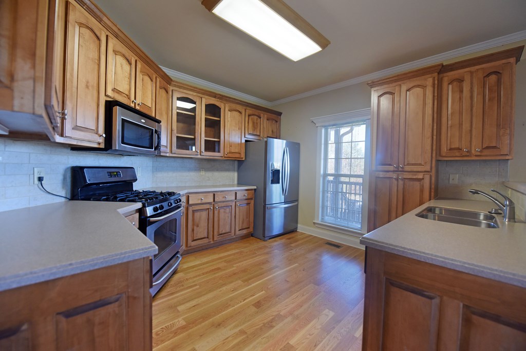 328 Asa Dorsey Road Cleveland, GA 30528 - Photo 3 of 35 a kitchen with stainless steel appliances granite countertop a refrigerator stove top oven and sink