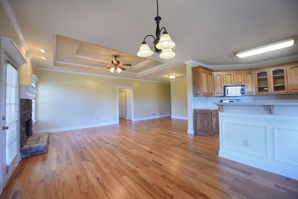 328 Asa Dorsey Road Cleveland, GA 30528 - Photo 6 of 35 a view of a kitchen center island wooden floor and a ceiling fan