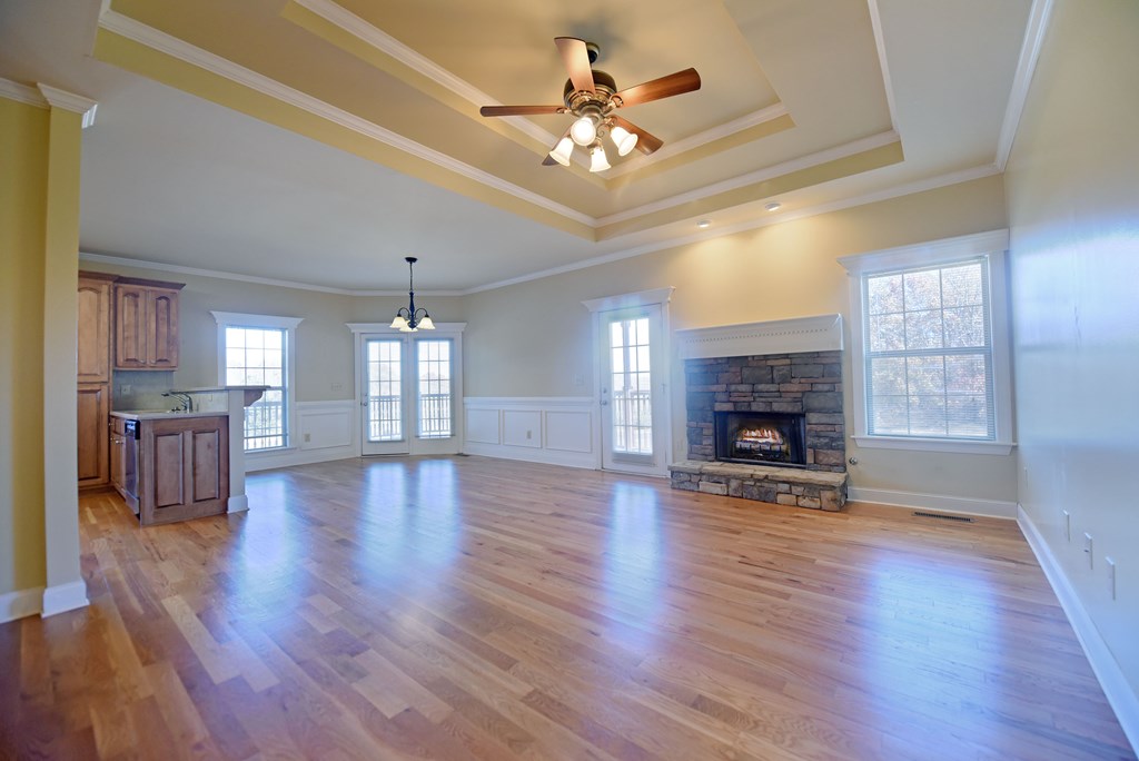 328 Asa Dorsey Road Cleveland, GA 30528 - Photo 7 of 35 an empty room with fireplace chandelier fan and windows