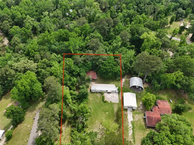 an aerial view of a house with swimming pool and garden view