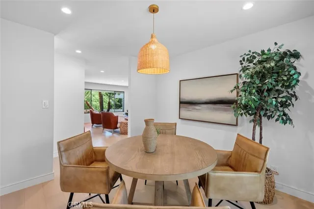 a dining room with furniture and a flat screen tv