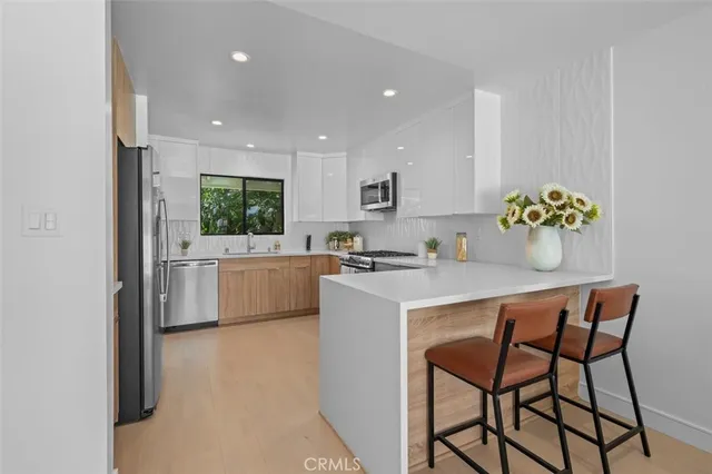 a kitchen with a refrigerator and a sink