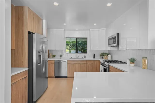 a kitchen with white cabinets and white appliances