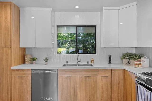 a kitchen with granite countertop a sink stove and cabinets