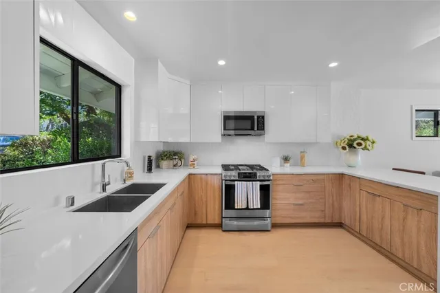 a kitchen with a refrigerator and a sink