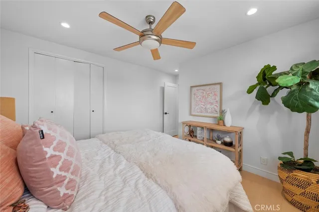 a spacious bedroom with a bed and a chandelier
