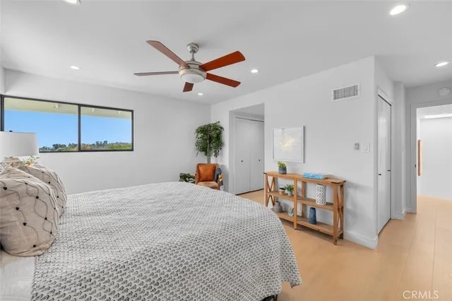 a bedroom with furniture and a chandelier