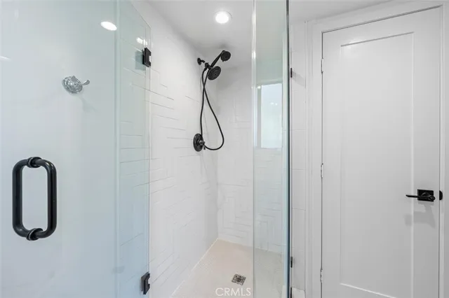 a en suite bathroom with a granite countertop sink and a mirror