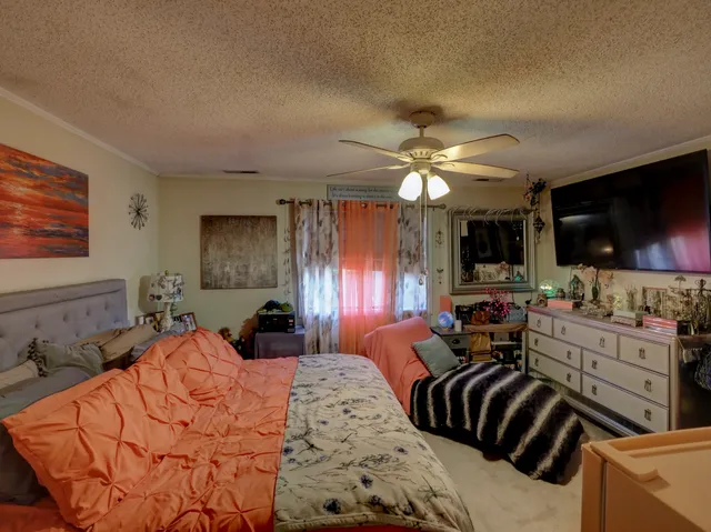 a bed room with a bed and a television