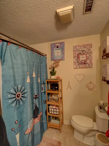 a bathroom with a toilet sink and shower