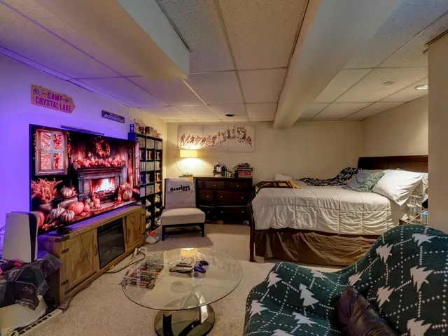 a bedroom with furniture and a flat screen tv