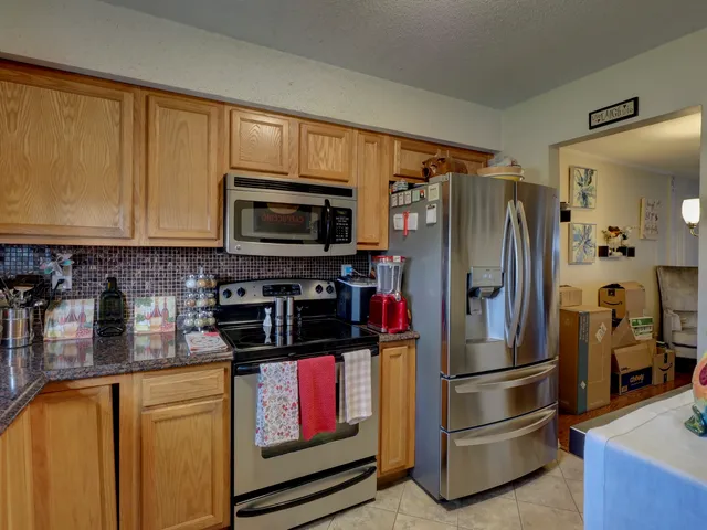 a kitchen with stainless steel appliances a refrigerator a stove and cabinets