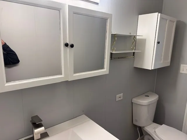 a bathroom with a toilet and a sink