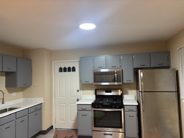 1316 Monroe Street Lake In The Hills, IL 60156 - Photo 3 of 20 a kitchen with a stainless steel appliances a refrigerator and a sink