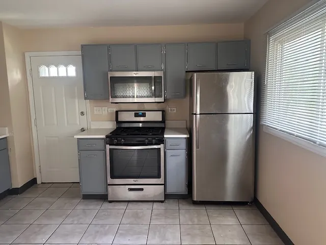 a kitchen with appliances and cabinets