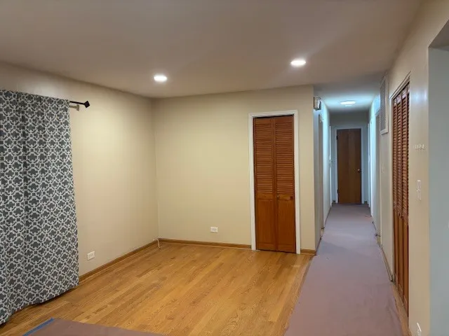 an empty room with closet and mirror
